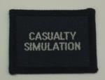 Navy blue cloth flash, to be worn on uniform by Red Cross Junior who holds a certificate in Casualty Simulation. With the words 'Casualty Simulation' in white.