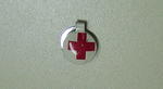 Small metal clip, white with the emblem.