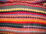 Multi-coloured crocheted blanket