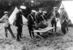 Members of Surrey/39 (Godalming) practising carrying casualty in blanket stretcher at Busbridge Camp
