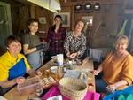 Group of Ukrainian refugee women preparing food for a fundraising event in Switzerland
