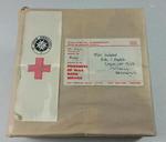 Reproduction Second World War Prisoners of War Book Parcel. Cardboard box covered with brown paper tied with string featuring two white labels, one of which contains the emblems of the British Red Cross Society and the Order of St John, the other giving the delivery details. Parcel has velcro tabs on the back for display purposes. Part of a collection of items which were used at the POW Exhibitions which were held during the Second World War.