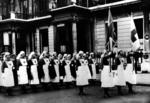 A group of female VADs in indoor uniform assembled outside British Red Cross headquarters in London