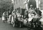 British Red Cross VADs with bicycles and tricycles outside Hammersmith Red Cross headquarters
