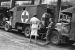 British Red Cross Officer Miss Perry stands by vehicles to distribute gifts