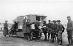 Wounded soldier being loaded into a motorised ambulance