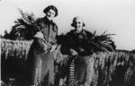 Enid Fordham and Irene England gathering flowers while working at Belsen