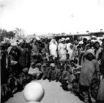 Black and white photograph. Group of refugees and Red Cross personnel, including Lady Limerick, at Multan Cantonment Camp in Pakistan