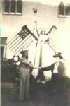 Three people in fancy dress posing with American flags