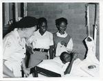 Mrs F Thomas with Juniors of the Botswana Red Cross visiting patients in hospital