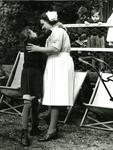 A child embracing a nurse who is helping her to stand at the Palace School in Ely