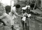 Black and white photograph. Disaster relief kits provided by the Junior Red Cross for victims of Hurricane Hattie