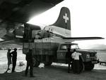 Black and white photograph. Unloading relief supplies in Najran