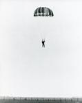 Black and white photograph used in Red Cross News of a Cheshire branch volunteer doing a parachute jump