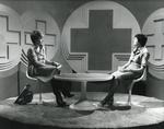 Black and white photograph of Judith Chalmers and Denise Barnett filming 'Home Nursing' for Tyne Tees Television