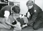 Black and white photograph of First Aid training