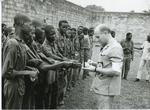 Black and white photograph of an ICRC delegate visiting prisoners of war in Nigeria