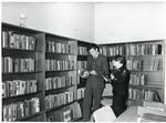 Black and white photograph of Bridget Harper in a Red Cross library