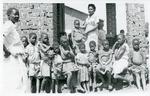 Black and white photograph of Malawi children with clothes from the British and Canadian Red Cross