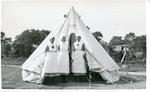 Black and white photograph of three British Red Cross members outside a bell tent