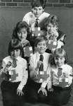Black and white photograph of British Red Cross Youth members with the new design of collecting box