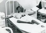 Black and white photograph of a patient undergoing rehabilitation treatment in Somalia