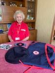 Patricia, British Red Cross volunteer, with her British Red Cross uniform.