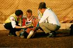 Photograph of an Injured Speedway Rider being attended to on the Track by Reading Centre Members and Doctor
