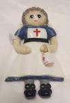 Dough doll in the form of a British Red Cross VAD with collecting tin