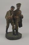 Model of soldier supporting a wounded comrade with arm in sling